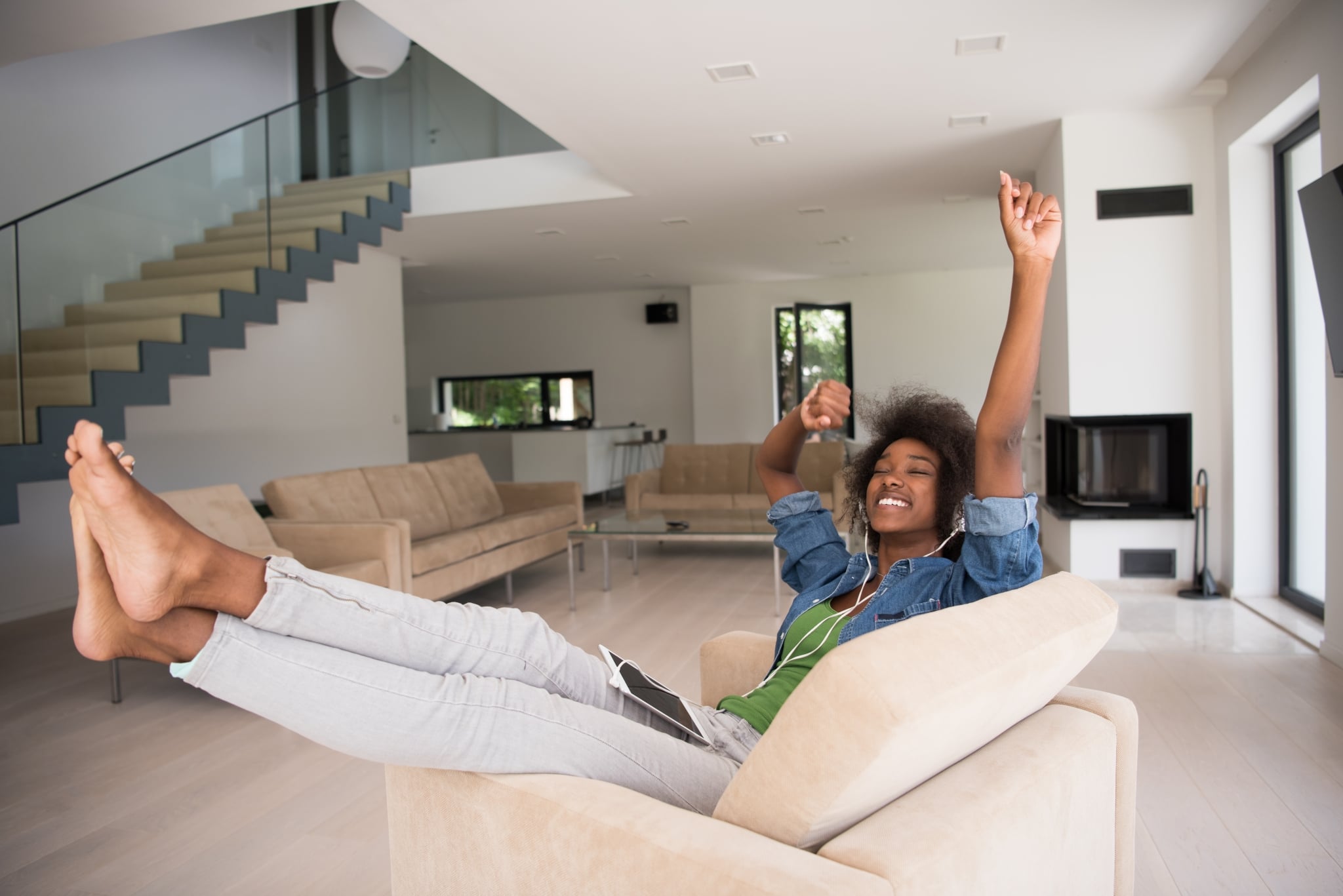 African American Woman At Home In Chair With Tablet And Head Pho