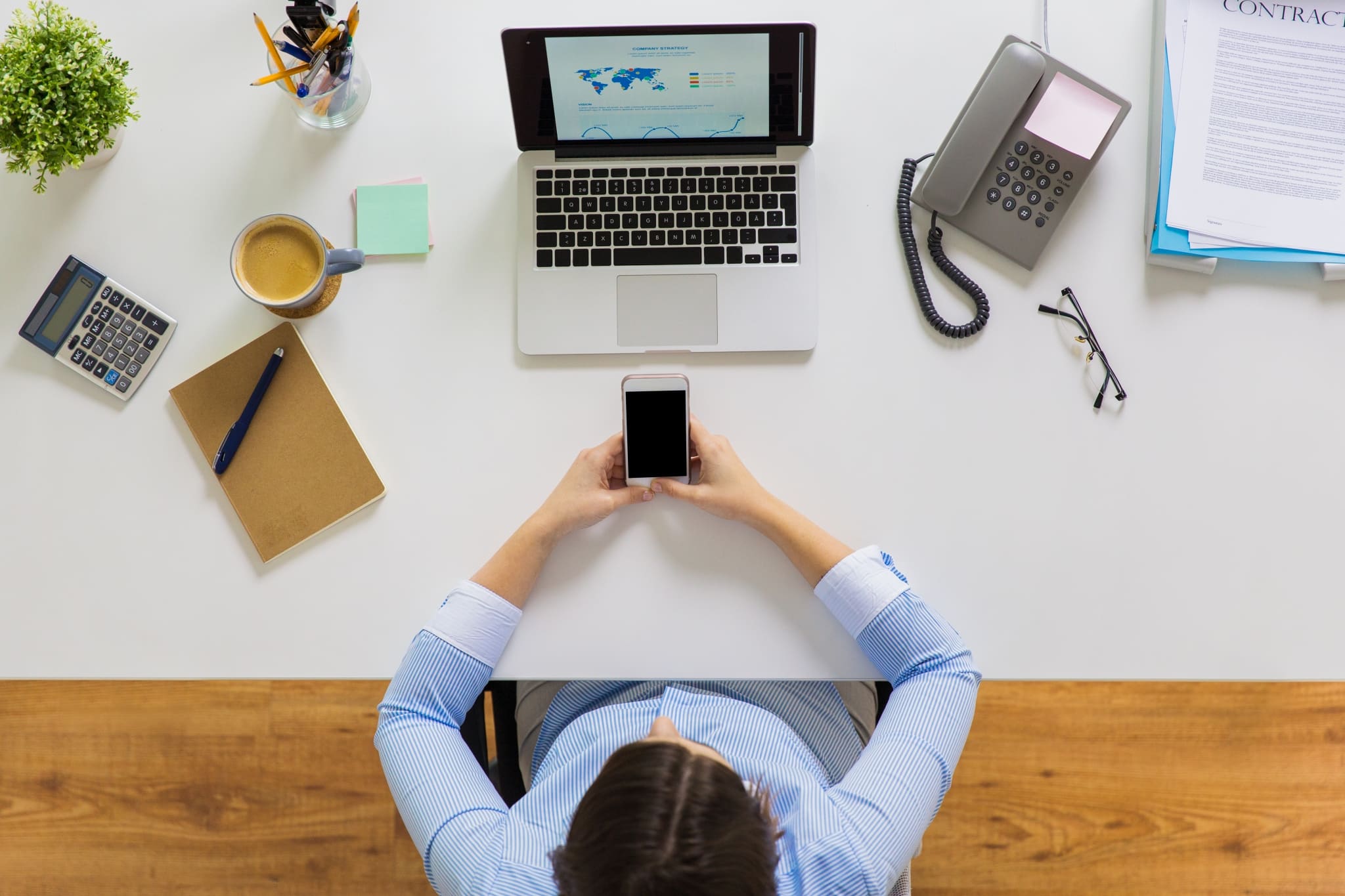 Businesswoman With Laptop And Smartphone At Office